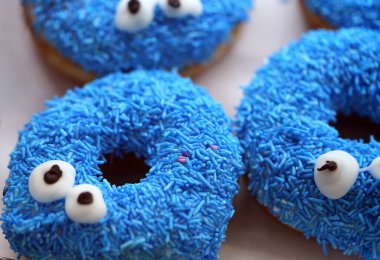 Lezzetli tatlı donutların arkaplanındaki resimde yüzleri gösteriliyor.