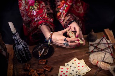 Gypsy fortune teller predicts the future with cards  clipart