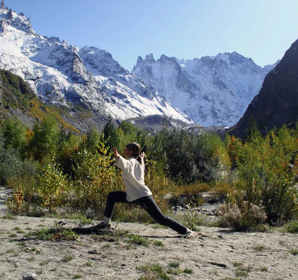 Nainen harrastaa joogaa vuoristoradalla. Matka elämäntapa Rentoudu — kuvapankkivalokuva