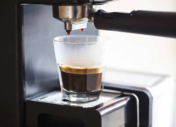 Espresso coffee pouring from coffee machine, espresso coffee drink