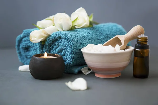 Spa still life with towels,rose flowers, bath salt and candle setting, wellness and spa still life composition