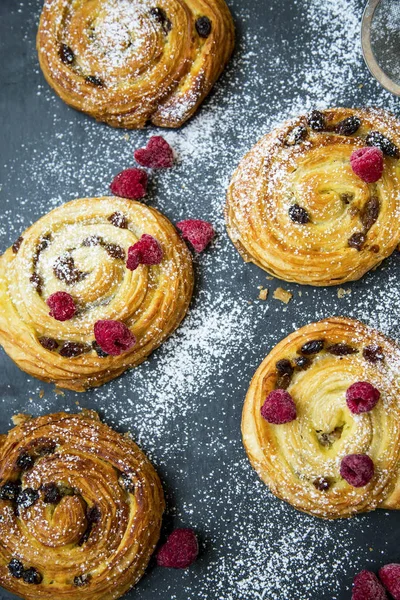 Panecillos de pastelería franceses con pasas, vainilla y frambuesas. P —  Fotos de Stock