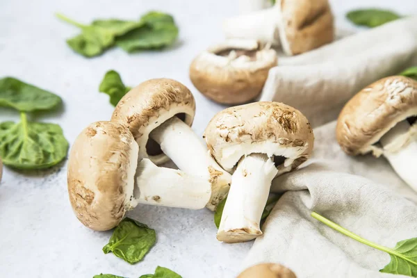 Champignon mushrooms closeup with spinach leaves, still life, he — Stock Photo, Image