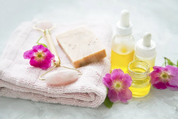 Spa still life with rosehip soap, flowers and oil — Stock Photo, Image