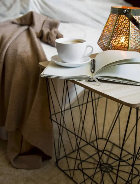 Home deco indoor with notebook, coffee cup on the table