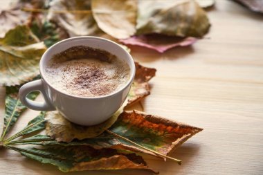 Ahşap masa üzerinde kurutulmuş yaprakları dekorasyon ile Sonbahar kahve fincanı, 