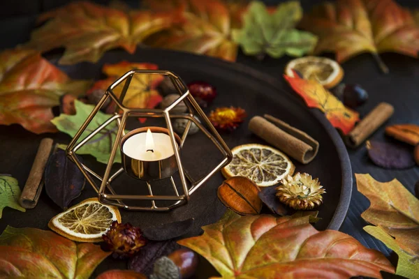 Fall candle decoration with dried leaves