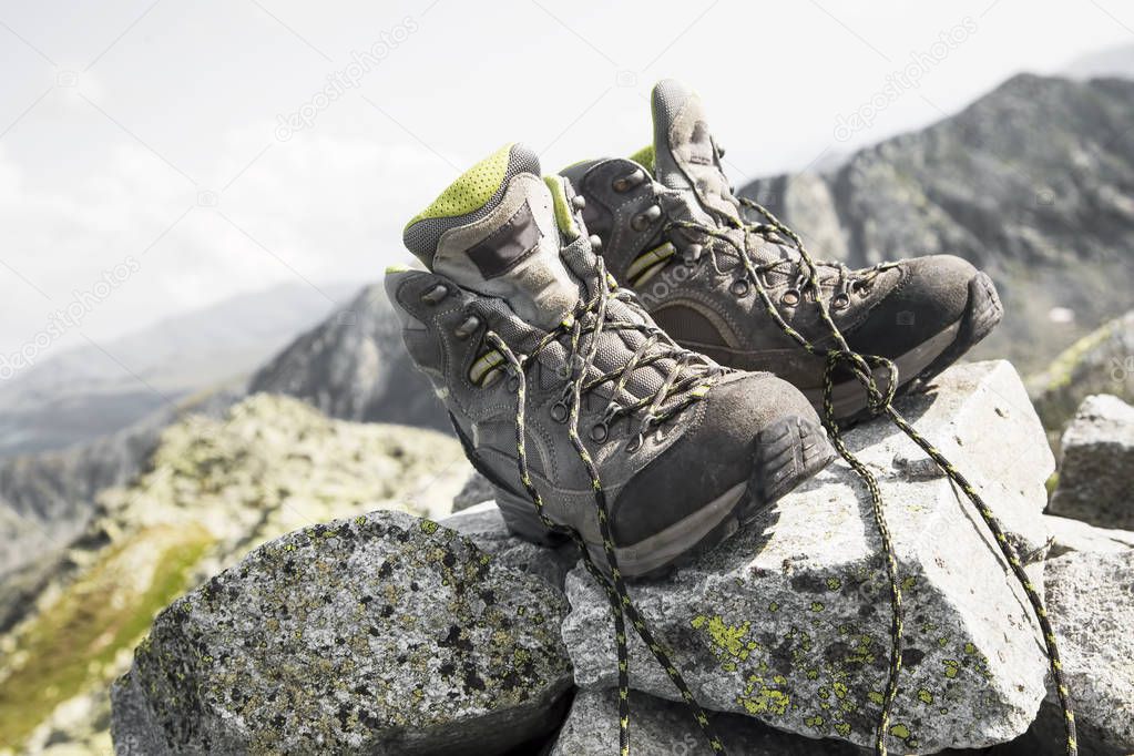 Pair of hiking boots on top of the mountain peak