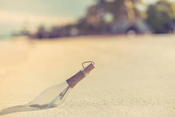 Message in the bottle. Conceptual image of dreams, thoughts and inspiration. Message in the bottle on sandy beach, relaxing background