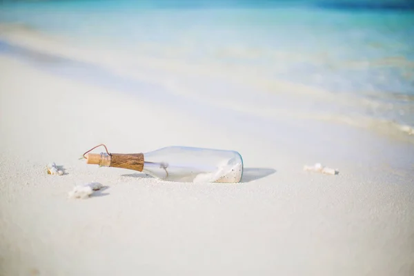 Message in the bottle. Conceptual image of dreams, thoughts and inspiration. Message in the bottle on sandy beach, relaxing background