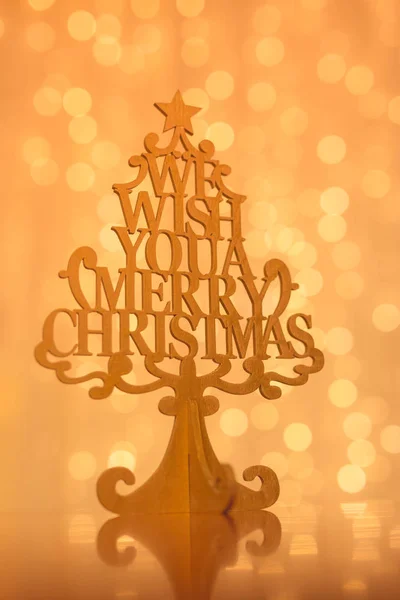 Merry Christmas sign in wooden Christmas tree. Winter holiday background, greeting card template