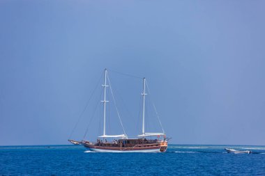 Yelkenli teknesi derin mavilikte seyrediyor. Güzel yelkenli yelkenli Mavi Akdeniz 'de yelken açar
