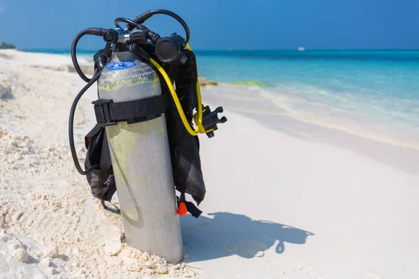 Scuba diving equipment on a tropical beach. Underwater diving equipment on a white sandy beach, exotic water sport and recreational activity accessory