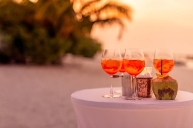 Aperol spreyli kokteyl içeceği, seçici odaklanma ve detaylar. Tropik plajda alkollü içecek. Plaj partisinde aperol spreyli kokteyller ve arka planda bulanık insanlar vardı. Sığ odak içinde sosyal etkinlik karamsar afiş tasarımı