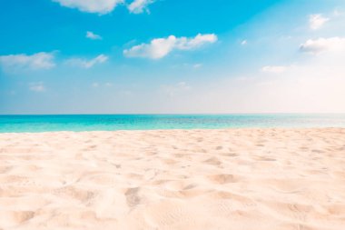 Güzel deniz manzarası. Canlı ve yumuşak renkler, rahatlatıcı güneş ışığı. Gökyüzündeki küçük bulutlar, sudaki güneşin yansıması ve kumsaldaki kum. Romantik zaman kavramı tropikal, kaygısız, sükunet ve pozitif titreşimlerde. 