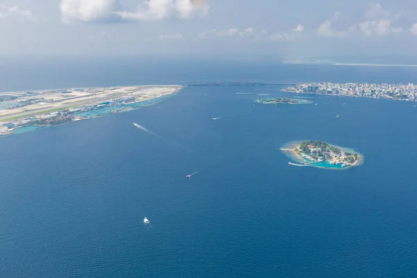 Capital of Maldives, Male. Aerial landscape and seascape. Airport island and main island with bridge connected