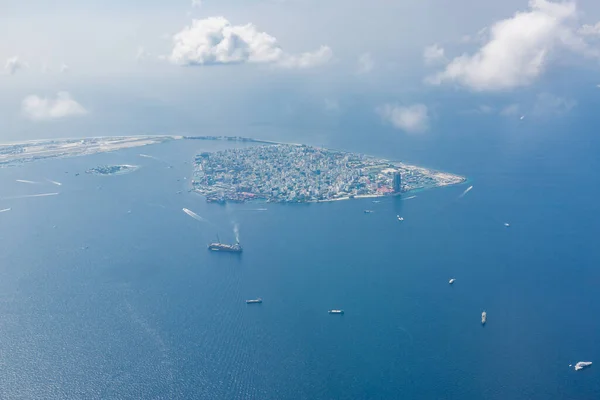Capital of Maldives, Male. Aerial landscape and seascape. Airport island and main island with bridge connected