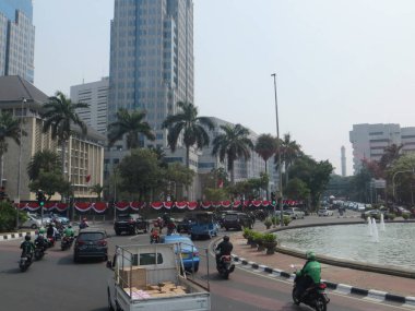 JAKARTA, INDONESIA - August 2, 2018: Traffic on Jalan Thamrin around Bundaran Bank Indonesia (Bank Indonesia Roundabout).