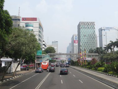 JAKARTA, INDONESIA - August 2, 2018: Traffic on Jalan Thamrin around Bundaran Bank Indonesia (Bank Indonesia Roundabout).
