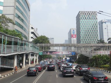 JAKARTA, INDONESIA - August 2, 2018: Traffic on Jalan Thamrin around Bundaran Bank Indonesia (Bank Indonesia Roundabout).