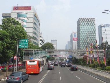JAKARTA, INDONESIA - August 2, 2018: Traffic on Jalan Thamrin around Bundaran Bank Indonesia (Bank Indonesia Roundabout).