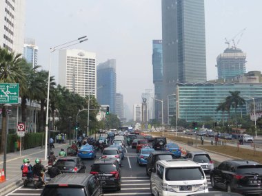 JAKARTA, INDONESIA - August 2, 2018: Traffic on Jalan Thamrin around Bundaran Hotel Indonesia (Hotel Indonesia Roundabout).