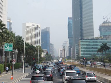 JAKARTA, INDONESIA - August 2, 2018: Traffic on Jalan Thamrin around Bundaran Hotel Indonesia (Hotel Indonesia Roundabout).
