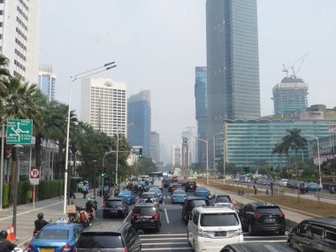 JAKARTA, INDONESIA - August 2, 2018: Traffic on Jalan Thamrin around Bundaran Hotel Indonesia (Hotel Indonesia Roundabout).
