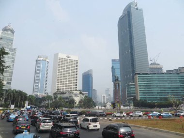 JAKARTA, INDONESIA - August 2, 2018: Traffic on Jalan Thamrin around Bundaran Hotel Indonesia (Hotel Indonesia Roundabout).