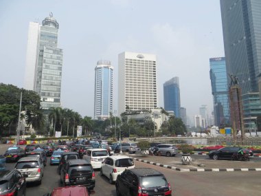 JAKARTA, INDONESIA - August 2, 2018: Traffic on Jalan Thamrin around Bundaran Hotel Indonesia (Hotel Indonesia Roundabout).