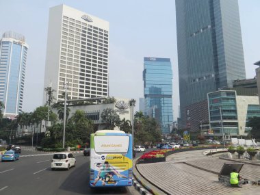 JAKARTA, INDONESIA - August 2, 2018: Traffic on Jalan Thamrin around Bundaran Hotel Indonesia (Hotel Indonesia Roundabout).