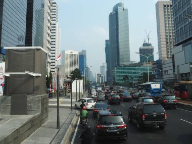 JAKARTA, INDONESIA - August 24, 2018: Traffic on Jalan Thamrin around Bundaran Hotel Indonesia (Hotel Indonesia Roundabout).