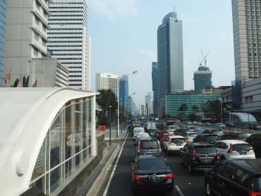 JAKARTA, INDONESIA - August 24, 2018: Traffic on Jalan Thamrin around Bundaran Hotel Indonesia (Hotel Indonesia Roundabout).