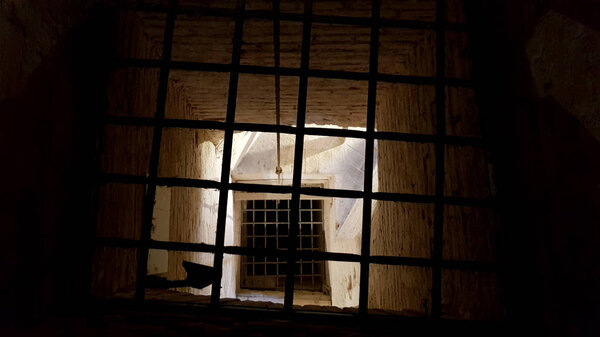 Ancient terrifying jails in italian castle with views through the bars