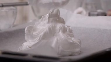 Pasta şefi beze düğün pastası için hazırlar.