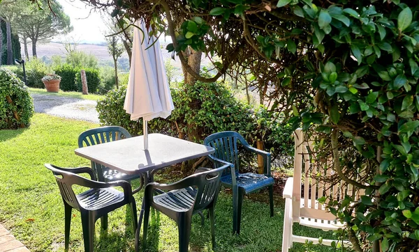 elegant relaxation area in the garden with chairs and table for an outdoor breakfast