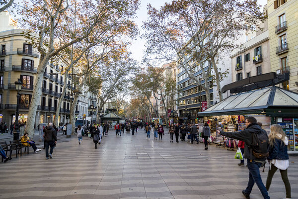 BARCELONA, SPAIN - DECEMBER 19, 2018: La Rambla in Barcelona, Spain. La Rambla is a street in central Barcelona, between El Raval and Barri Gotic district
