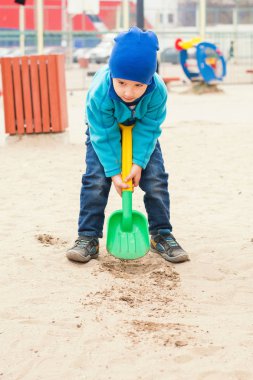 çocuk 4 yaşında bir kürek kum ile