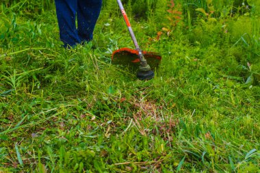 çim adam el ile çim biçme makinesi ile mows