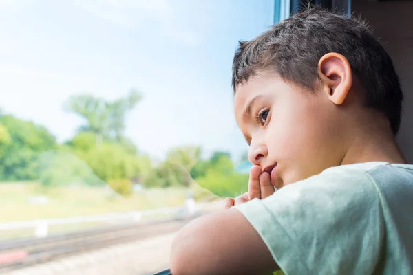 Sad Boy Rides Train Looks Out Window — Stock Photo, Image