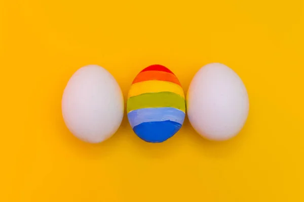 concept of LGBT. one colored egg between two white eggs