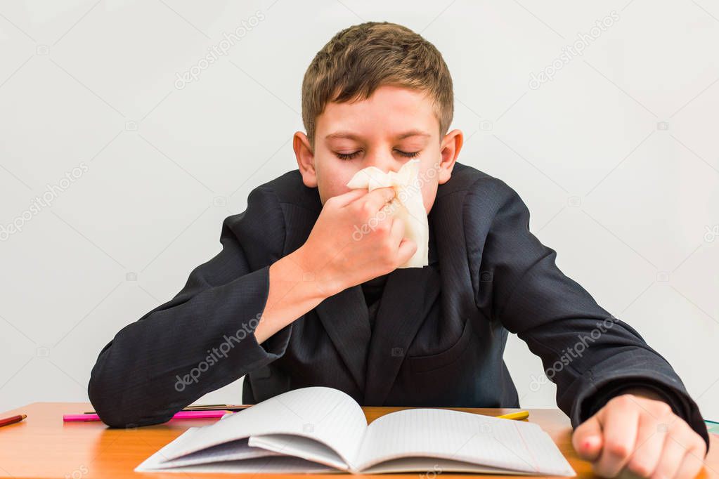 cold boy wipes his nose with a napkin