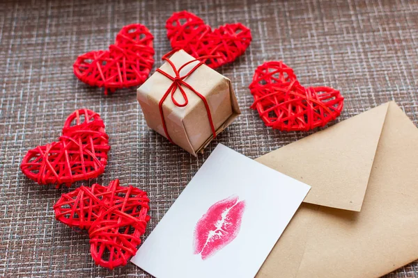 Kraft envelope, gift, hearts and card with a lip print. the concept of Valentine's day
