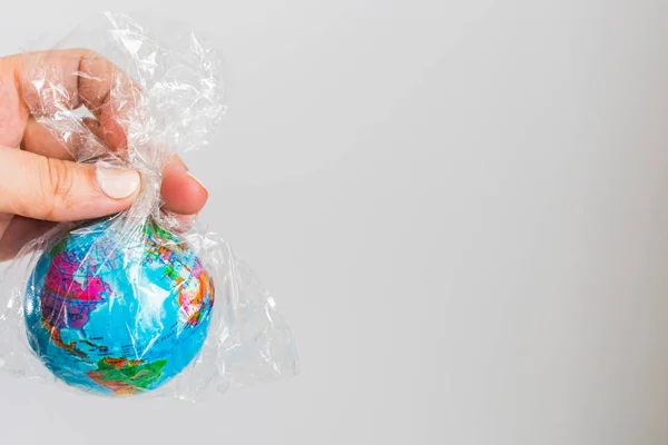 small globe of Earth in a plastic bag. The concept of the pure Earth