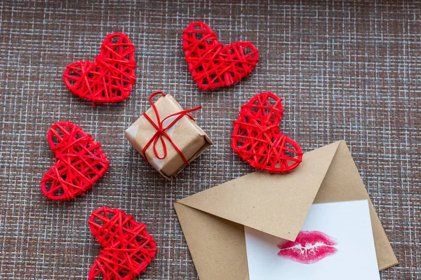 Kraft envelope, gift, hearts and card with a lip print. the concept of Valentine\'s day