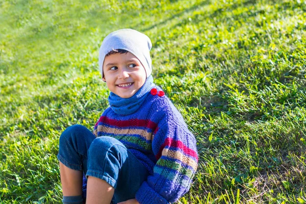 Cheerful Boy Hat Sweater Sitting Grass — Stock Photo, Image