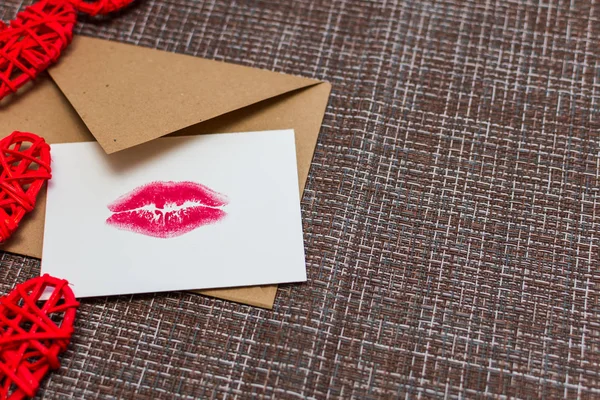 Kraft envelope, hearts and card with a lip print. the concept of Valentine\'s day
