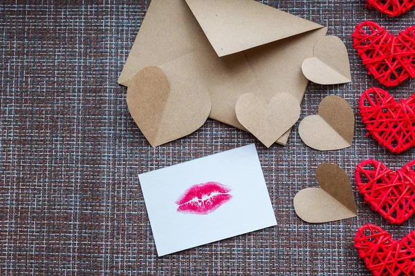 Kraft envelope, hearts and card with a lip print. the concept of Valentine\'s day