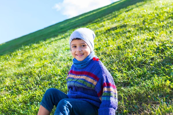 Cheerful Boy Hat Sweater Sitting Grass — Stock Photo, Image