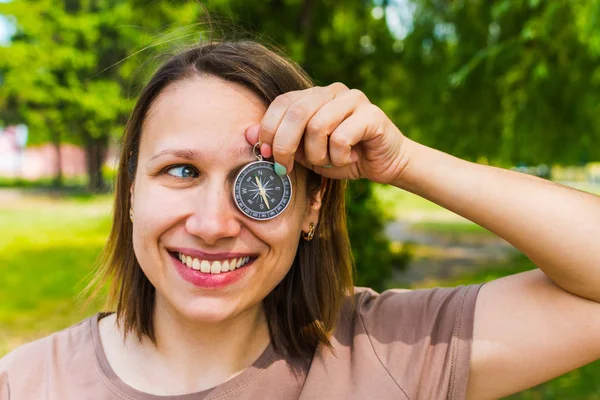 Улыбающаяся привлекательная женщина держит компас — стоковое фото